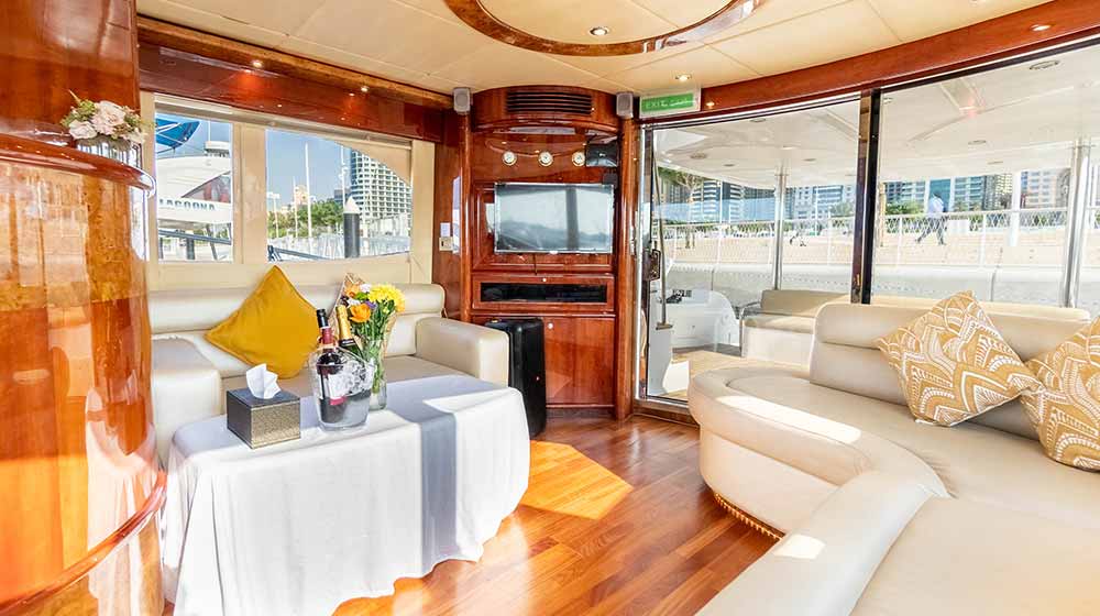 silvercreek yacht saloon with comfy sofas, led tv, hifi speakers,  bottle of wines, large windows and glass doors